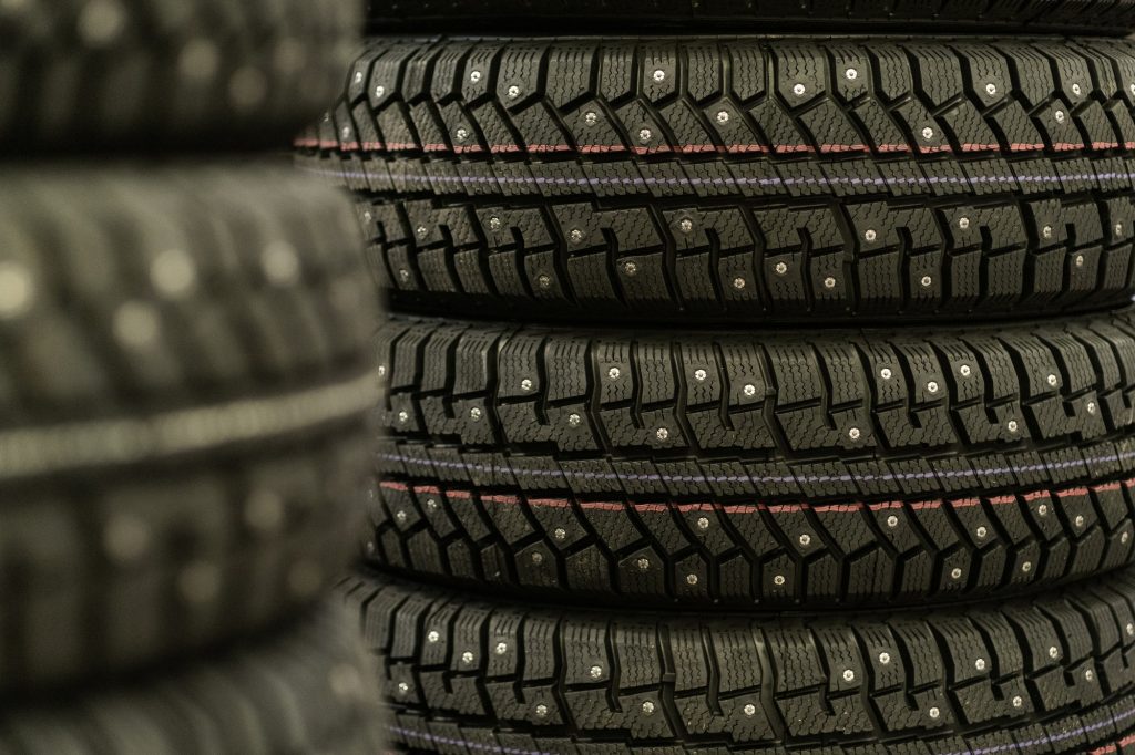 Sale of car tires for sale in the store. Many new winter tires lie
